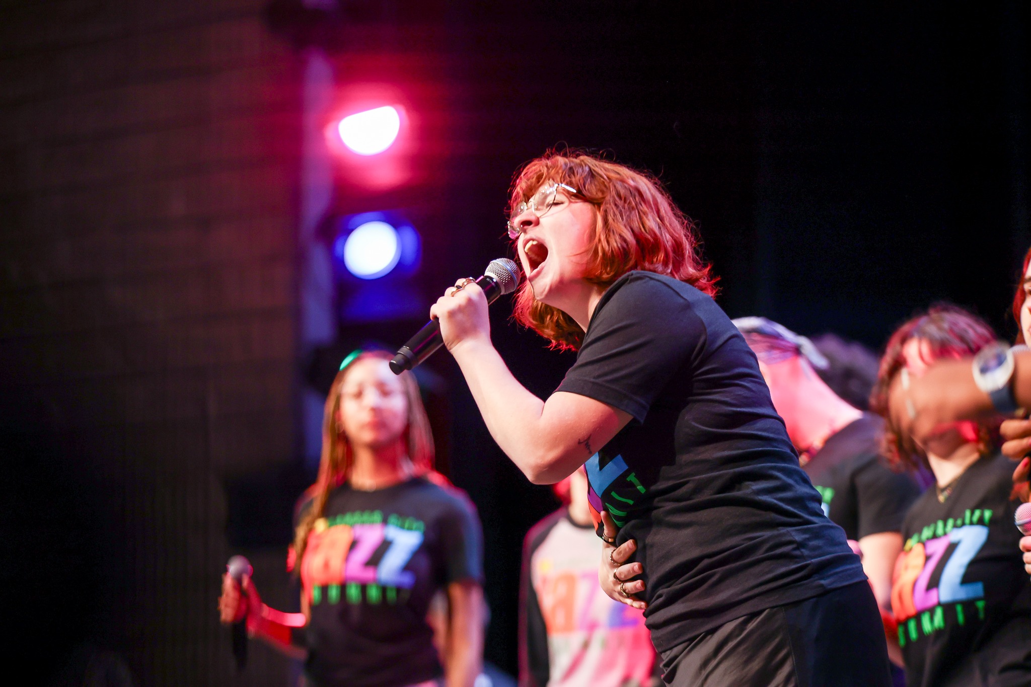 Girl in black shirt singing.