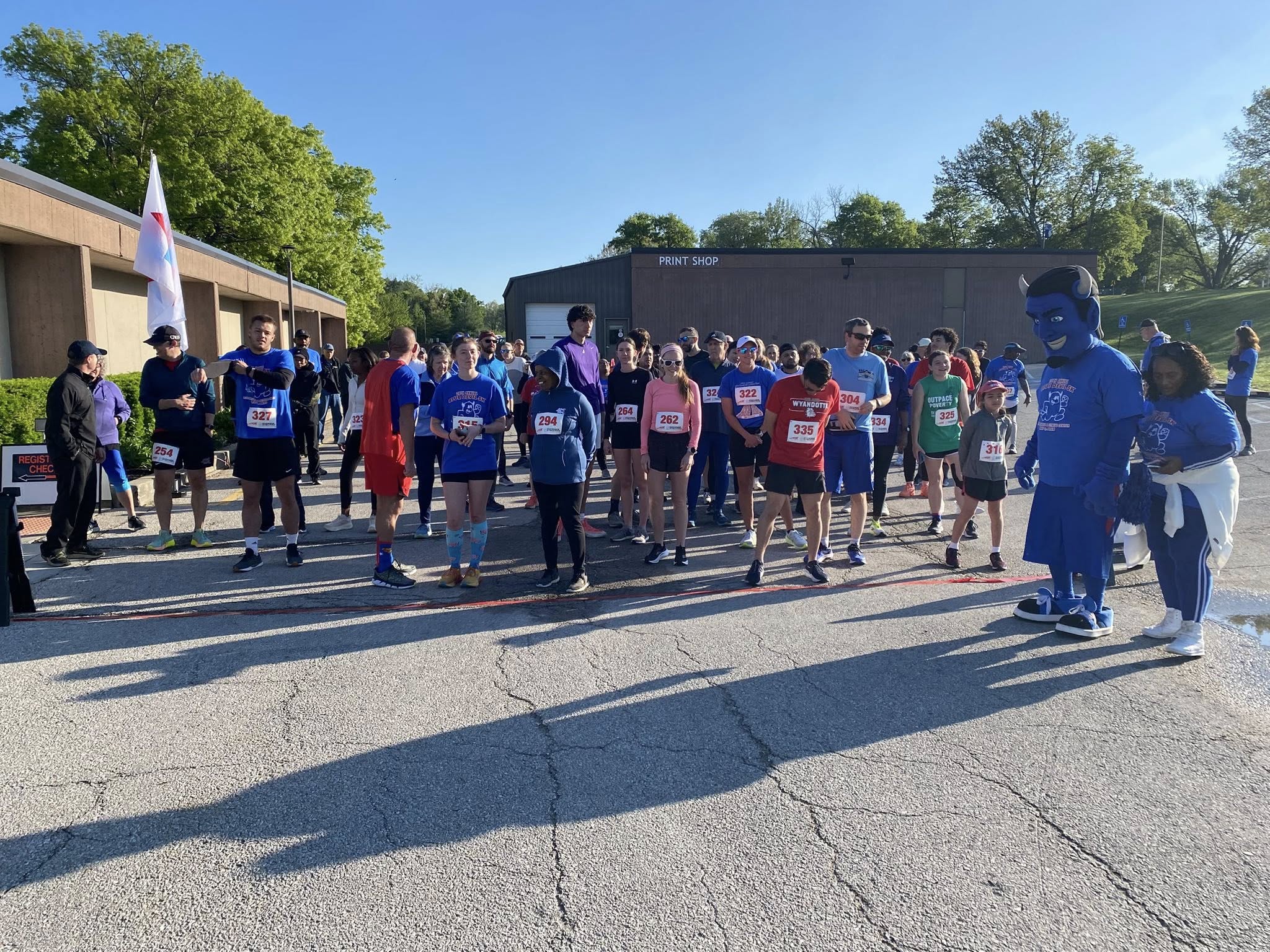Group of people standing at starting line.