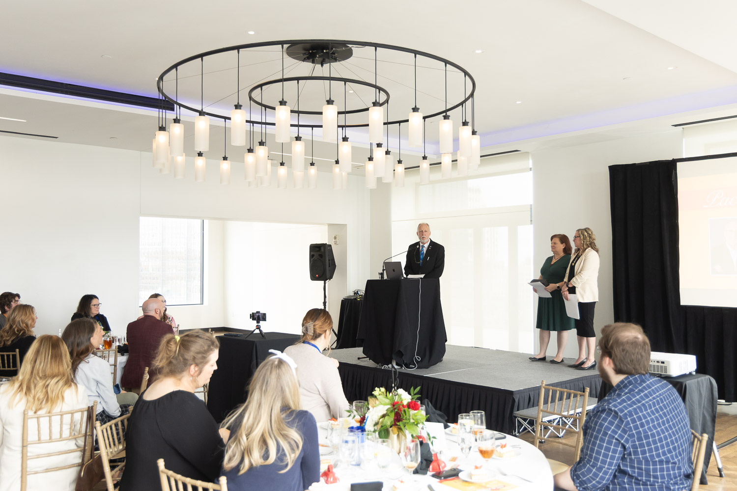 Dr. Greg Mosier standing at podium, accepting an award.