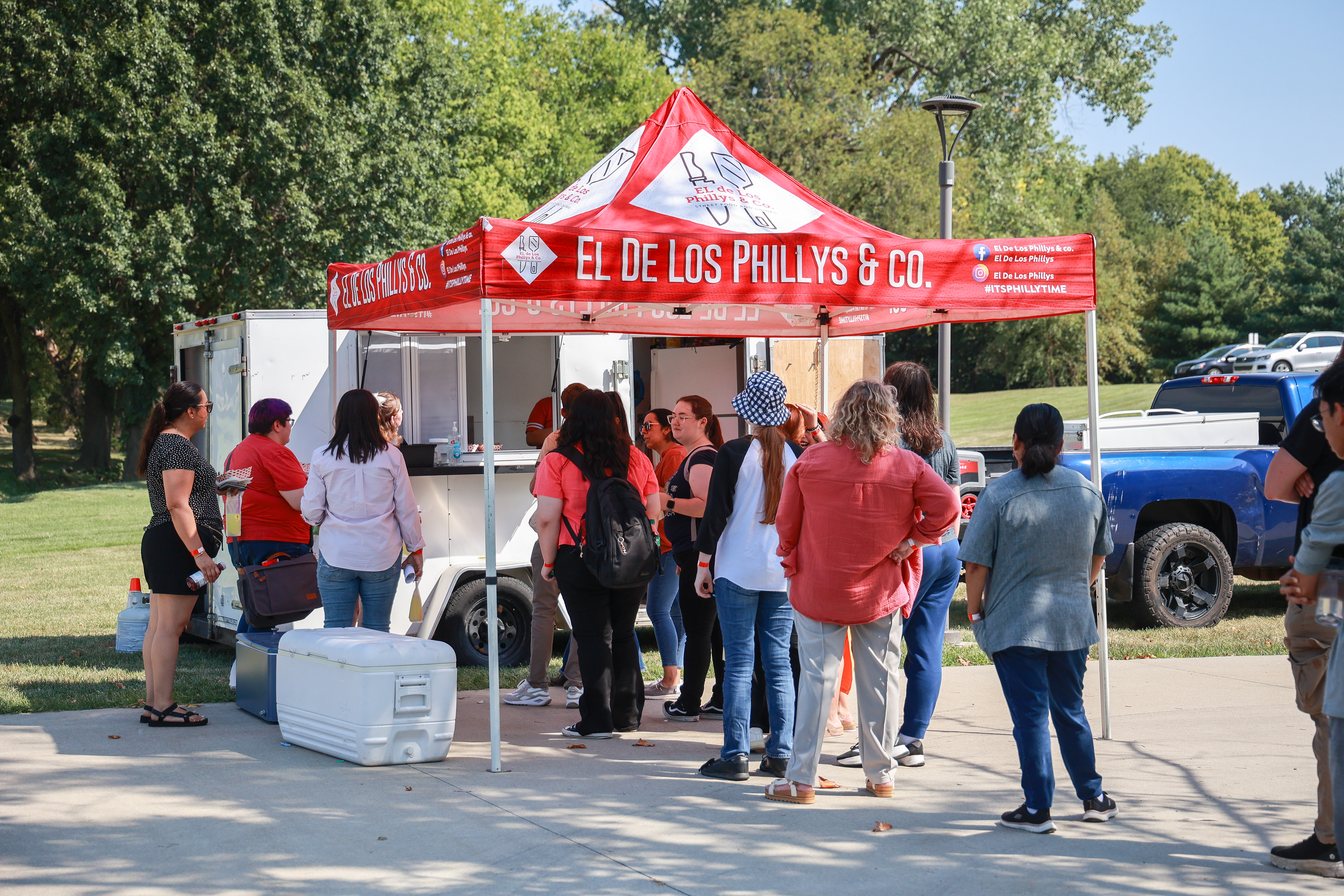 Young people standing in line at a food truck.