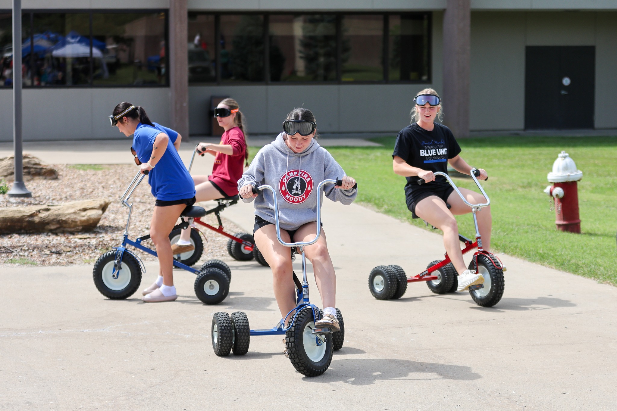 Students riding tricycles.