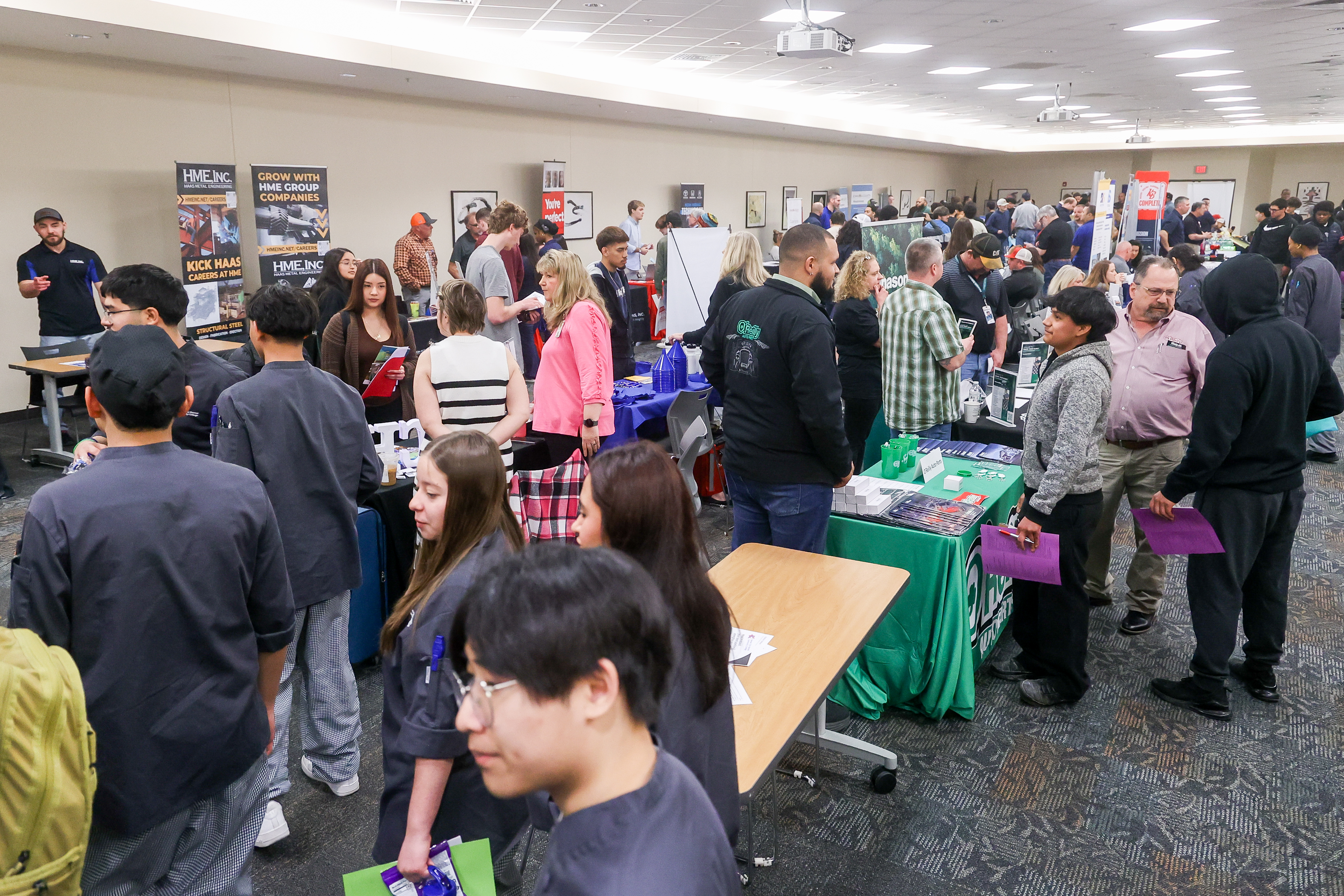 Room full of people meeting with different employers.