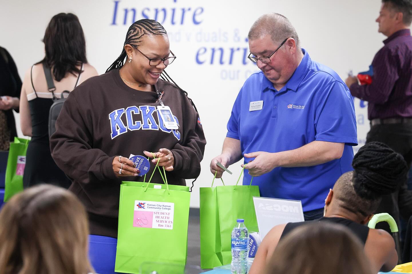 Man and woman talk to each other at event.