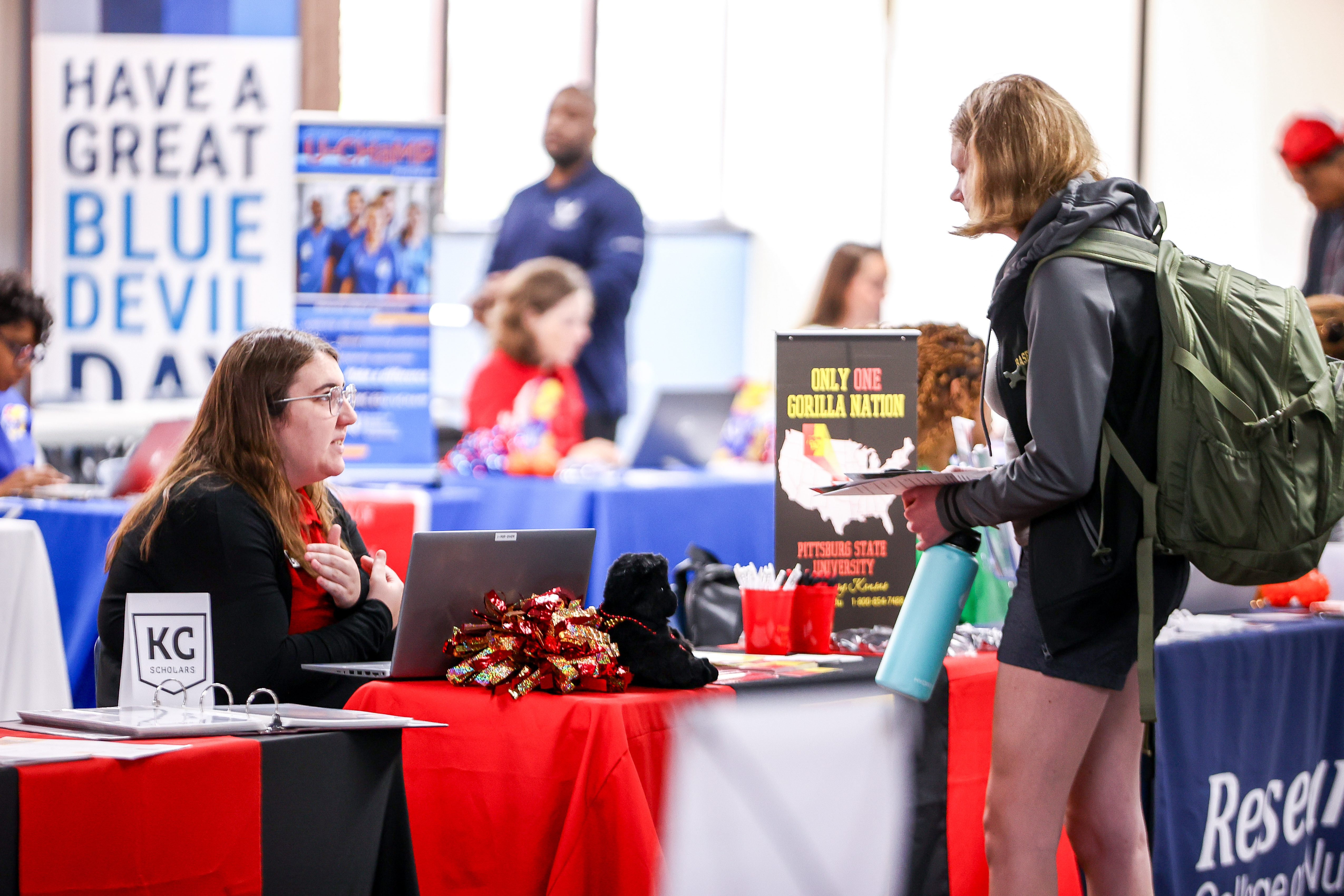 Admissions representative talks with student.