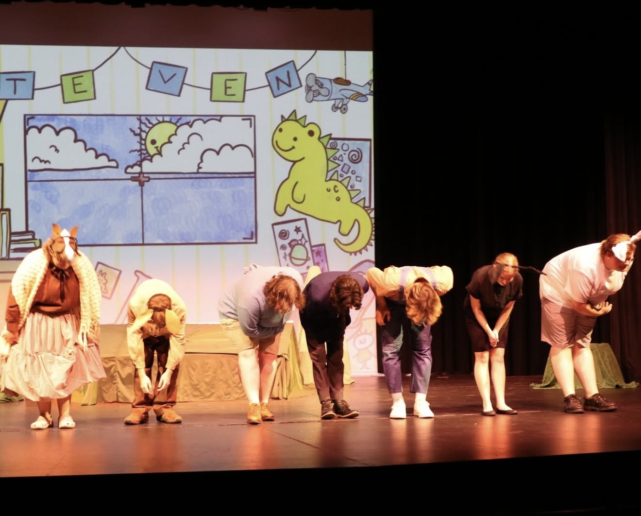 Students take their final bow on stage.